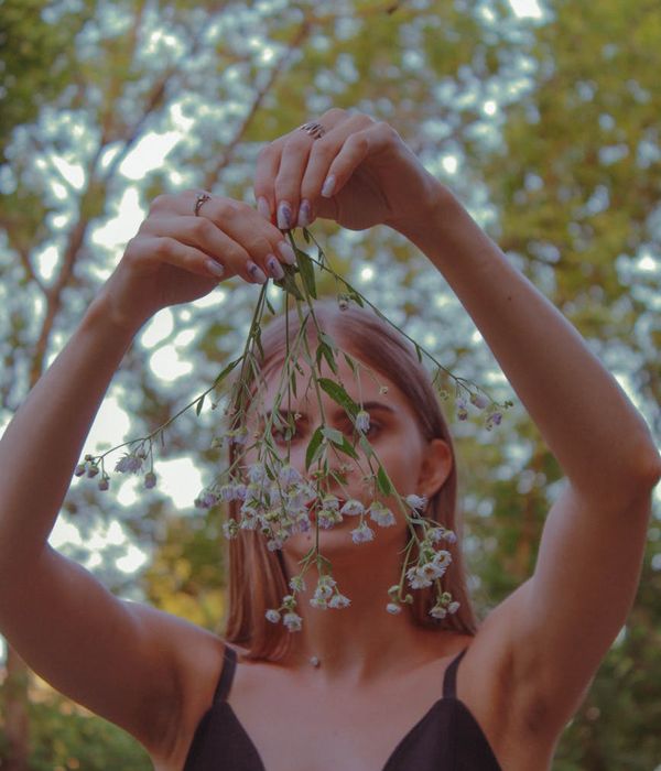Woman in a calm yoga pose in a minimalist dark environment.